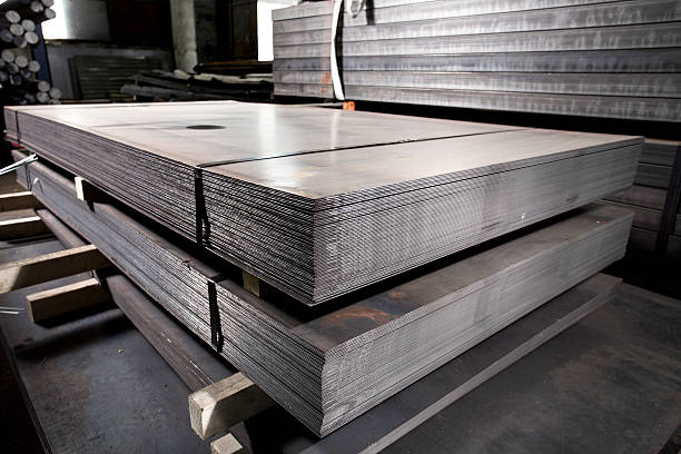 Stainless steel sheets deposited in stacks in a warehouse